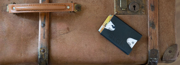 Black and Bamboo STAK Wallet on a suitcase.